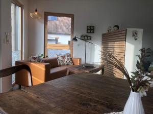 a living room with a table and a couch at Ferienwohnung Haas Oberschopfheim in Friesenheim