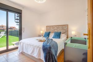 a bedroom with a bed and a sink and a tub at Encantadora Casa Tara in Lajares +30 photos