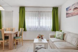 a living room with a couch and a table at Night and day 8 in Predazzo