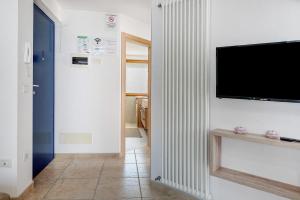 a living room with a flat screen tv on a wall at Night and day 8 in Predazzo