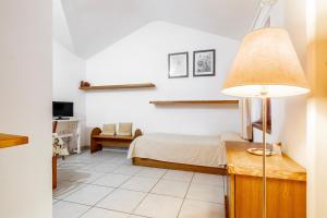 a bedroom with a bed and a table with a lamp at La Capannuccia D in Ansedónia