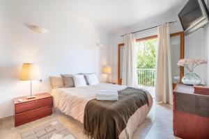 a bedroom with a large bed and a window at Ca Na Kika in Alcudia