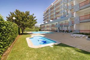 a swimming pool in front of a building at T2 com piscina centro Vilamoura in Vilamoura