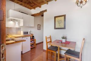 a kitchen and dining room with a table and chairs at Can Mussenya 1 in Illes Balears