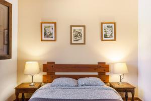 a bedroom with a bed and two tables with lamps at Can Mussenya 1 in Illes Balears