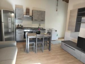 a kitchen with a table and a kitchen with stainless steel appliances at Teseo Holiday in Castelvetrano Selinunte