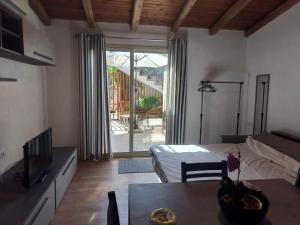 a room with a bed and a table and a television at Teseo Holiday in Castelvetrano Selinunte