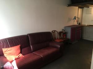 a living room with a brown couch and a table at Maison St Ringo cozy apartment in Lyon