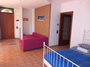 a room with a bed and a couch and a door at Villetta G in Senigallia
