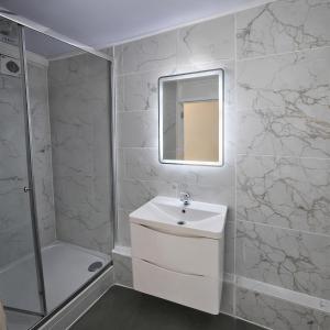 a white bathroom with a sink and a shower at ValueStays Chalvey Free Parking in Slough