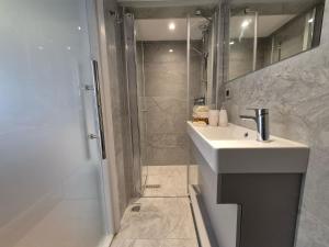a bathroom with a sink and a shower at Kavcıoğlu Rooms in Urla +27 photos