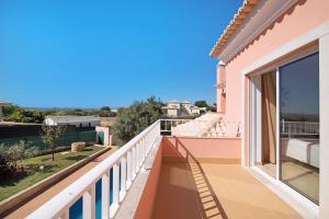 a balcony with a view of a house at Casa Tulipas in Loulé