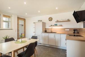 a kitchen with a table and chairs in a room at Ferienwohnung Pusteblume in Neukirch