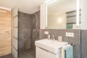 a bathroom with a sink and a shower at Ferienwohnung Pusteblume in Neukirch +18 photos