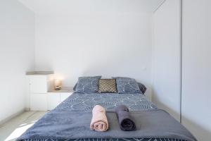 a bedroom with a bed with towels on it at Maison de vacances Chez André in Meslan +12 photos