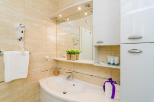 un baño con lavabo y espejo en Apartments Regina Maris, en Klek 92 fotos más