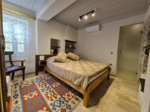 a bedroom with a bed and a desk and a window at Kavcıoğlu Rooms in Urla