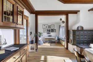 a kitchen with wooden cabinets and a dining room at Bei Kompis in Jenbach