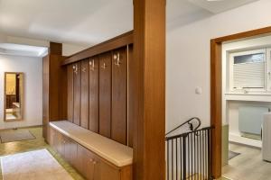 a hallway with wood paneling and a stair case at Bei Kompis in Jenbach +17 photos