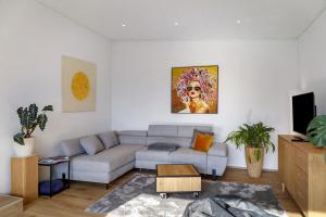 a living room with a couch and a table at Bei Kompis in Jenbach
