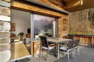 a dining room with a table and chairs on a patio at Bei Kompis in Jenbach