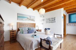 a bedroom with a large bed and a table at Vista Tostón in El Cotillo