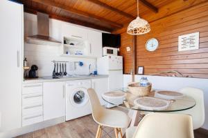 a kitchen with a table and chairs in a kitchen at Vista Tostón in El Cotillo +16 photos