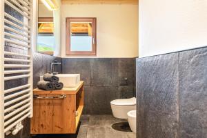 a bathroom with a sink and a toilet and a window at Zu Grof Morgenrot in Castelrotto +18 photos
