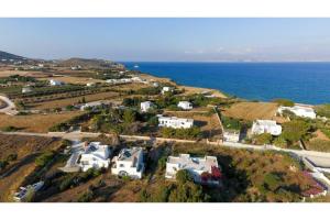 an aerial view of a house on a hill next to the ocean at Green Retreats 2 Paros in Isterni