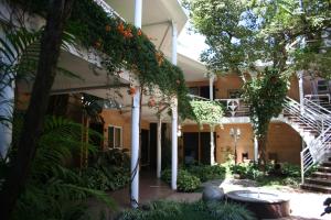 an outside view of a building with plants at Hotel Ciudad Vieja in Guatemala