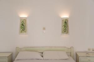 a bedroom with two lights above a bed at Green Retreats 2 Paros in Isterni