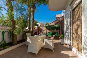 a patio with a table and chairs on a balcony at Villetta a Torre Lapillo in Torre Lapillo