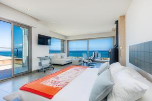 a bedroom with a large bed with a view of the ocean at Bohemi in Son Serra de Marina