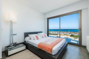 a bedroom with a bed with a view of the ocean at Bohemi in Son Serra de Marina +27 photos