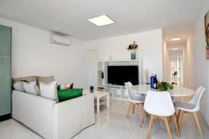 a living room with a couch and a table at Kay 4 in La Santa