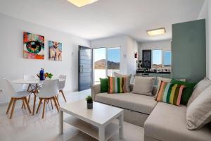 a living room with a couch and a table at Kay 4 in La Santa +15 photos