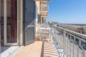 a table on the balcony of a house at A Casa Mia in Floridia