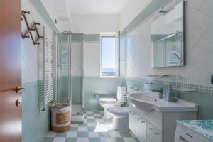 a bathroom with a sink toilet and a window at A Casa Mia in Floridia +18 photos