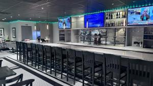 a bar in a restaurant with chairs and televisions at DoubleTree by Hilton Newark Penn Station, NJ in Newark