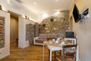 a living room with a stone wall at Bellavista Cottage in Barberino di Mugello