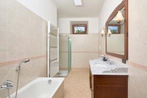 a bathroom with two sinks and a shower at Appartamento Ania vista castello in Tenno +37 photos