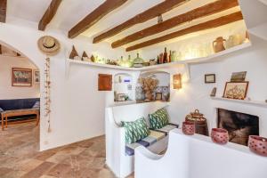 a living room with white walls and a fireplace at Can Sans in Banyalbufar +17 photos