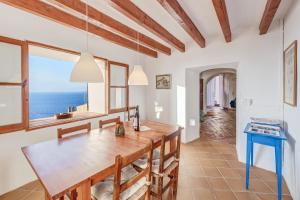 a dining room with a table and a view of the ocean at Can Sans in Banyalbufar