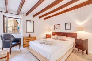 a bedroom with a bed and a desk and a chair at Can Sans in Banyalbufar