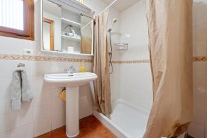 a bathroom with a sink and a shower at Ca Cedó in Serra de Almós +19 photos