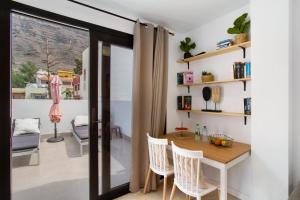 a dining room with a table and chairs at Dreaming Penthouse Mogan in Mogán