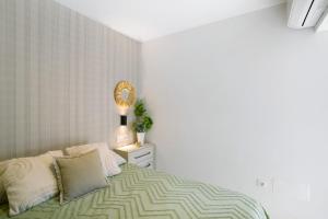 a bedroom with a bed and a mirror on a dresser at Dreaming Penthouse Mogan in Mogán