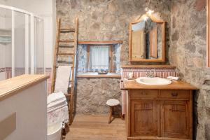 a bathroom with a sink and a mirror and a ladder at Chalet El Deroch - Bellamonte in Bellamonte +21 photos