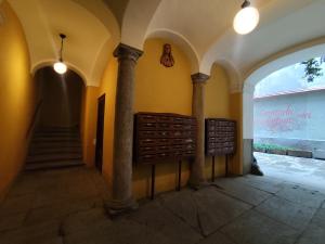 a hallway with columns and a staircase in a building at Calin Apartment in Turin