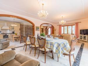 a dining room and living room with a table and chairs at Villa Torre in Cala Santanyi